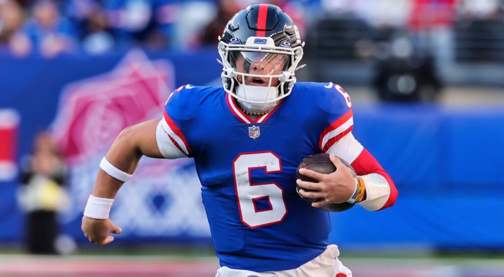 Jaxson Dart running with the football