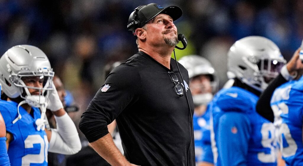 Dan Campbell looks on.