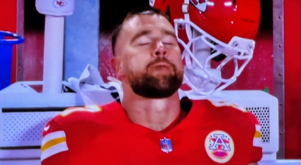 Travis Kelce looking on.